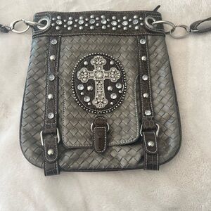 Like new western style purse with bling/bling cross. Silver with brown accents.